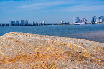 A Scene with a Rock Platform against a Modern City Skyline
