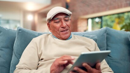 Tablet, relax and senior man on sofa in home reading blog post for news in living room on weekend. Happy, retirement and elderly male person with digital technology for online headline in apartment.