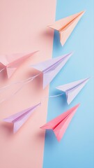 Colorful paper airplanes in soft pastel shades flying against a split background of pink and blue, symbolizing creativity, playfulness, and freedom in design.