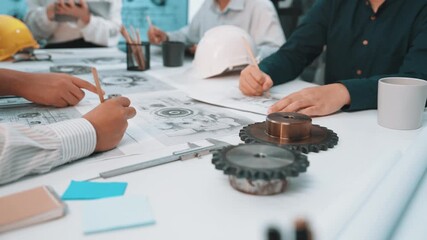 A diverse team of engineers engaged in a collaborative project, analyzing technical drawings and using tools in a modern workspace. Focus on teamwork and creative solutions. SACTR - Powered by Adobe