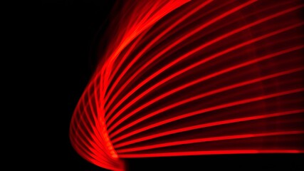 Vibrant red light streaks are dynamically creating intricate patterns and shapes against a contrasting dark backdrop