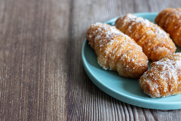 Traditional Catalan Xuixos from Girona Covered in Sugar on a Plate