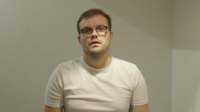 A man speaks in a flat, expressionless tone &mdash; example of monotone communication, poor presentation skills, and unengaging speech style.