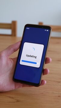 Vertical shot of smartphone doing software update.