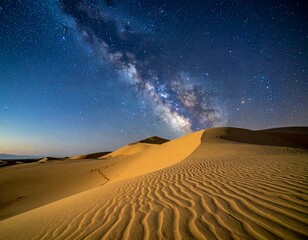 Sweeping desert sand dunes at night under Milky Way and starry sky