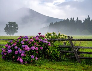 Misty mountain scene featuring colorful flowers, a rustic fence, and lush green meadows