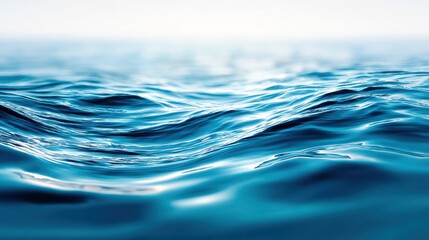 Close up of gentle ocean waves with a soft hazy horizon and light reflecting on the water's surface