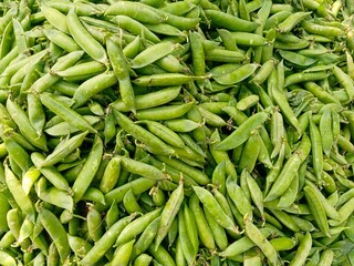 fresh green peas heap at market place