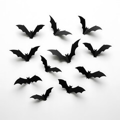 Group of black paper bats flying isolated on white background