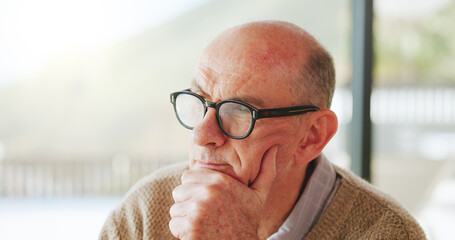 House, thinking and senior man with decision, remember or nostalgia with contemplation. Apartment, pensioner or mature person with glasses, past reflection or memory with choice, retirement or wonder