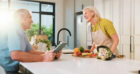 Smile, flowers and cooking with old couple in kitchen of home for anniversary celebration, romance or tablet. Love, online recipe and bouquet with senior man and woman in house for date and meal prep