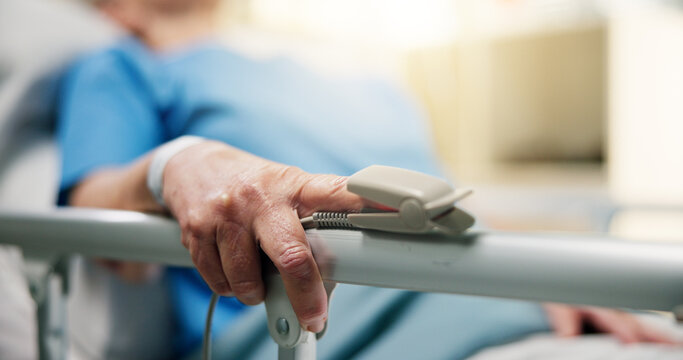 Hands, old person and oximeter in hospital bed to monitor pulse, blood pressure and surgery recovery. Closeup, elderly patient and medical machine to track oxygen, chronic condition and critical care