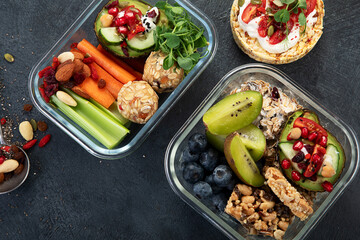 Bbox containing fresh fruits, vegetables, sandwiches, and nuts.