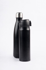 Two black drinking bottles are placed on a white background, creating a strong and clean contrast