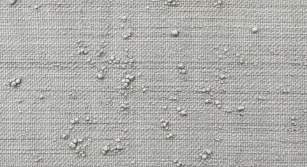 Detailed closeup of a textured gray fabric with raised bumps, creating a unique and tactile surface for backgrounds and design elements