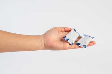 Plastic bag snack packaging and hand holding isolated on white background