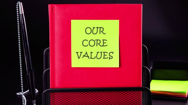 Business value and our core values concept. Animation of the conceptual text of OUR CORE VALUES on a yellow sticker stuck on a business notebook