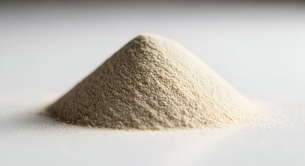 Pile of baking dry yeast on a white surface for bread dough rising process