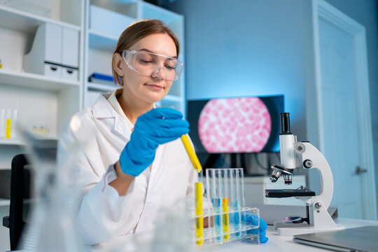 Caucasian female scientist in white lab coat working in the laboratory. 