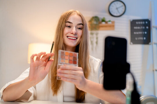 Caucasian young beauty blogger recording video content about cosmetics. - Powered by Adobe