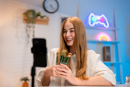 Caucasian young beauty blogger recording video content about cosmetics. - Powered by Adobe
