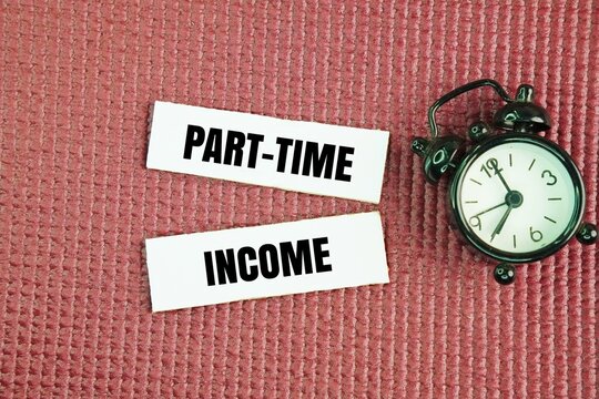 Clock and paper with the word Part-time income. earned through various opportunities, such as retail, food service, or event staff positions, or through freelance work, tutoring, and online ventures