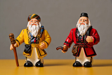 Two vintage figurines of bearded men in colorful attire retro antique