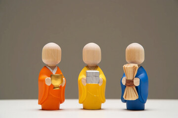 Three Wooden Monk Figurines Holding Gifts on White Surface monks figures