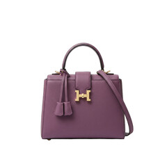 Elegant Purple Crocodile Textured Handbag With Gold H Clasp and Tassel Detail Isolated On Transparent Background Studio Shot