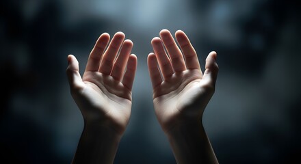 Hands reaching up towards the light, symbolizing hope, prayer, or spiritual connection
