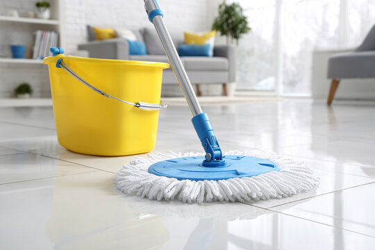 Modern floor cleaning with microfiber mop and yellow bucket on white background