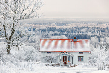 Idyllic old cottage by in a scenic winter view