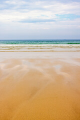 Beach with wet sand pattern and a beautiful view to the horizon