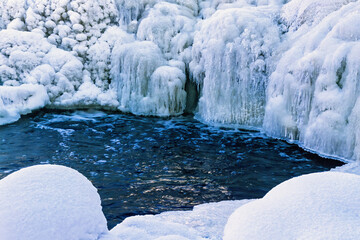Frozen waterfall by a pond a cold winter day