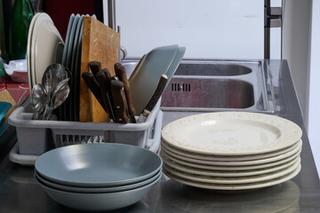 filled dish dryer and plates on counter