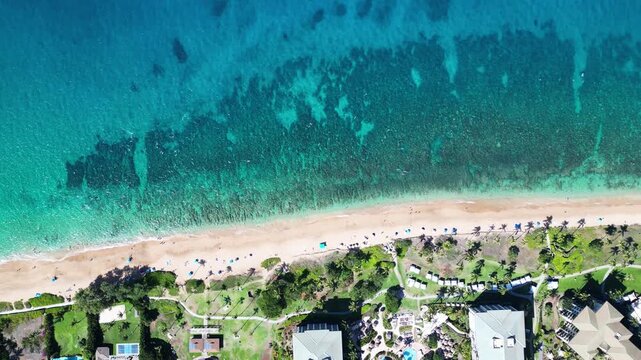 Static overhead drone of Maui&rsquo;s Airport Beach: shallow water, visible reef, umbrellas