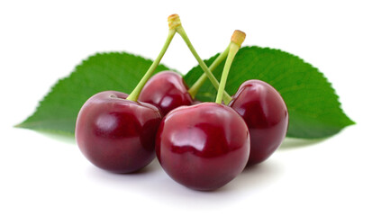 Fresh red cherries with green leaves isolated on white