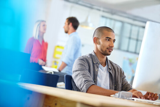 Marketing, research or man in office with desktop, trend update or browse in industry news. Digital, coworking or brand consultant in agency with tech, online article or reading for company report.