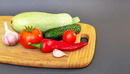 Composition of fresh vegetables on a wooden surface
