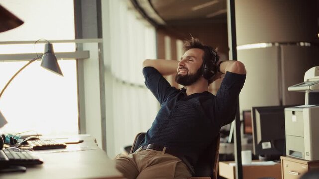 Relaxed Businessman Enjoying Music During Work Break
