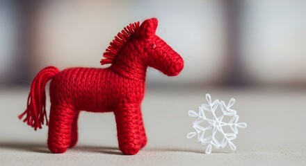Red crocheted horse figurine with white snowflake decoration  