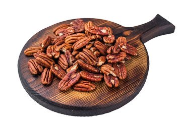 Brown pecan halves displayed on a textured dark board over a plain white backdrop giving a natural rustic look suited for food and nutrition content
