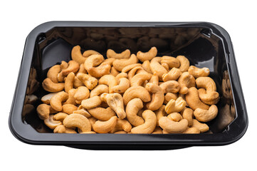 Cashew nuts packed in a black plastic container on a bright white background creating a clean ingredient