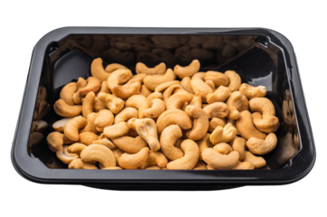 Cashew nuts packed in a black plastic container on a bright white background creating a clean ingredient
