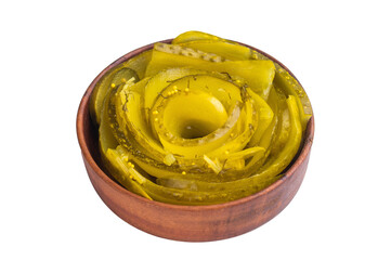 Spiral sliced pickles in a wooden bowl on white background, tangy brined cucumbers with dill and mustard seeds in top view.