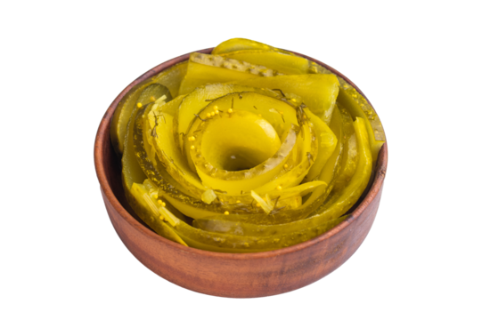 Spiral sliced pickles in a wooden bowl on white background, tangy brined cucumbers with dill and mustard seeds in top view.