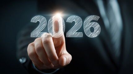 Businessman Touching 2026 – Future Goals and Strategies. Close-up of a businessman touching the glowing numbers 2026 on a digital interface. Goals, objectives, strategy, planning, growth, performance 