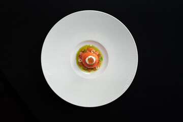 Elegant presentation of a gourmet meal on a white plate, showcasing a delicious dish. The composition is artistic and minimalist