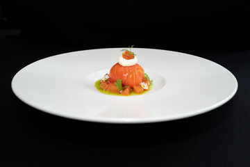 A gourmet dish artistically presented on a white plate, showcasing culinary excellence