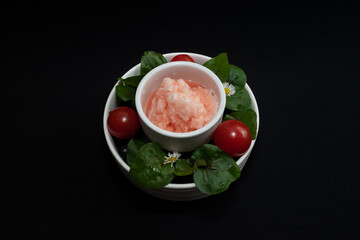 Delicious sorbet, beautifully served with tomatoes and greens, on a simple plate